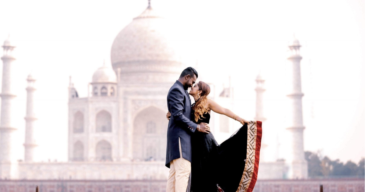 A-tourist-poses-for-photographs-at-Taj-Mahal | ContentGarden