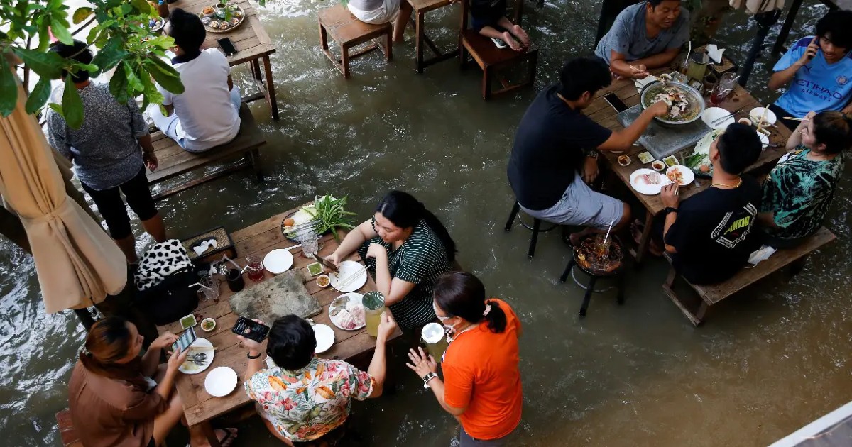 Thailand’s Riverside Restaurant Goes Viral For Offering Dining Experience In Floodwaters