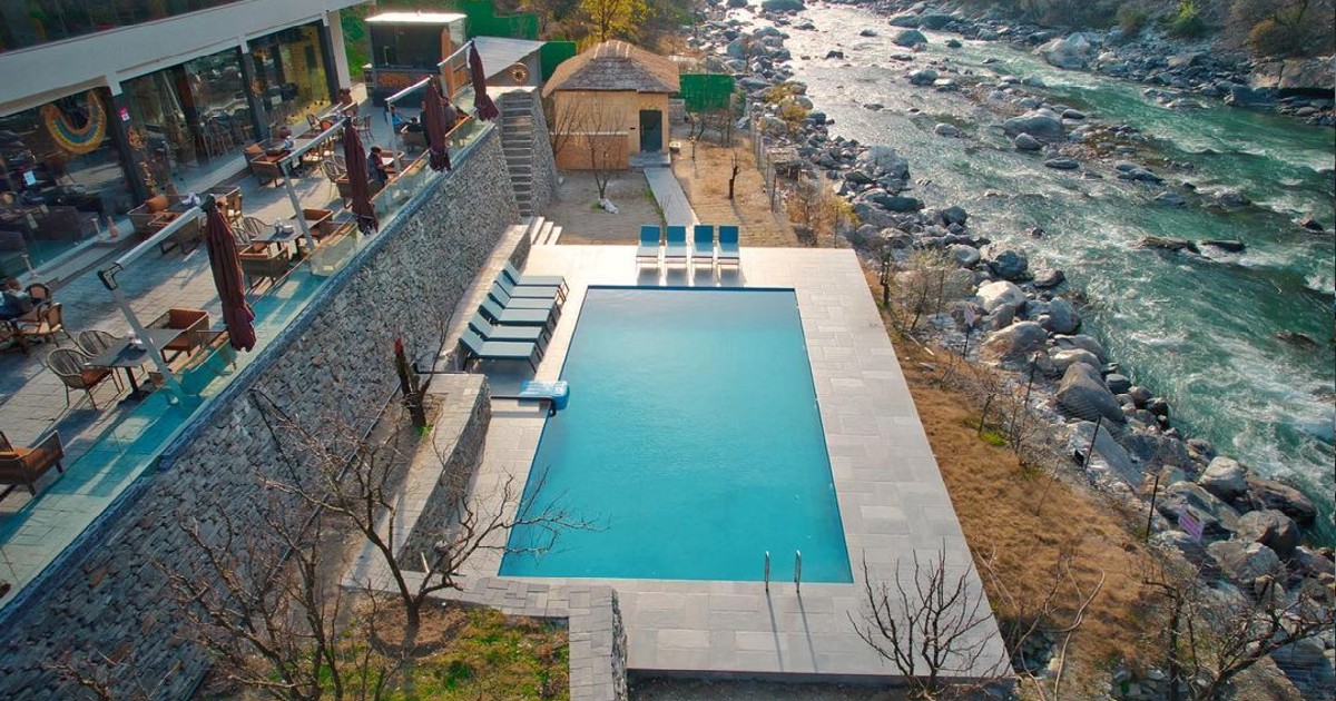 This Riverside Resort Near Parvati Valley Has An Outdoor Pool Overlooking The Mountains
