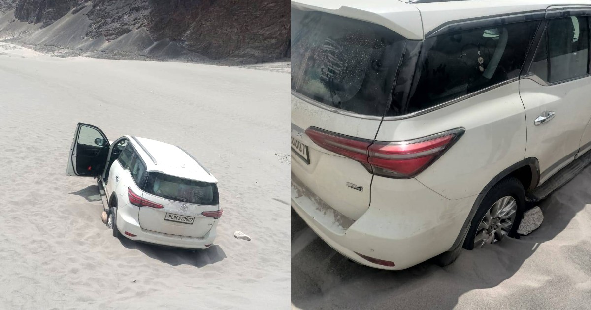 tourists drive suv in ladakh desert