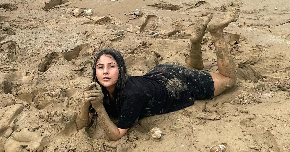 Shehnaaz Gill Enjoys Mud Spa By Rolling On Beach; Fans Call Her Down To Earth