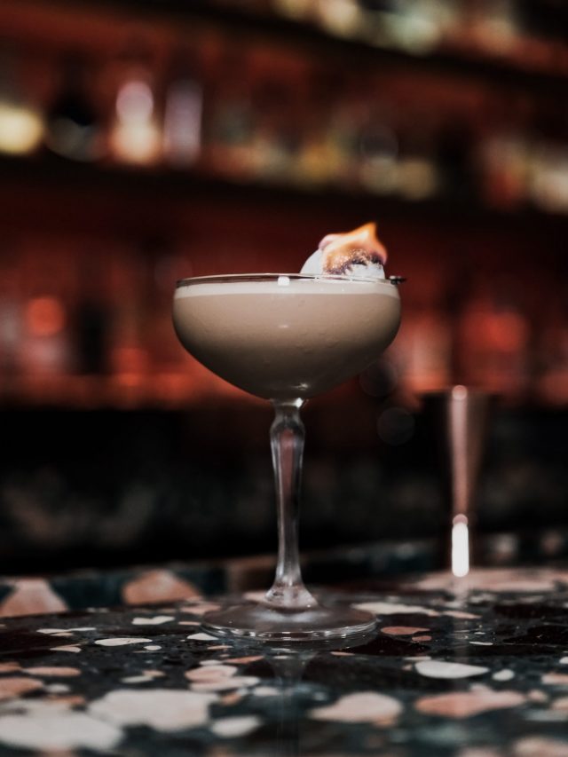 free-photo-of-cocktail-with-flame-in-glass-at-bar-counter