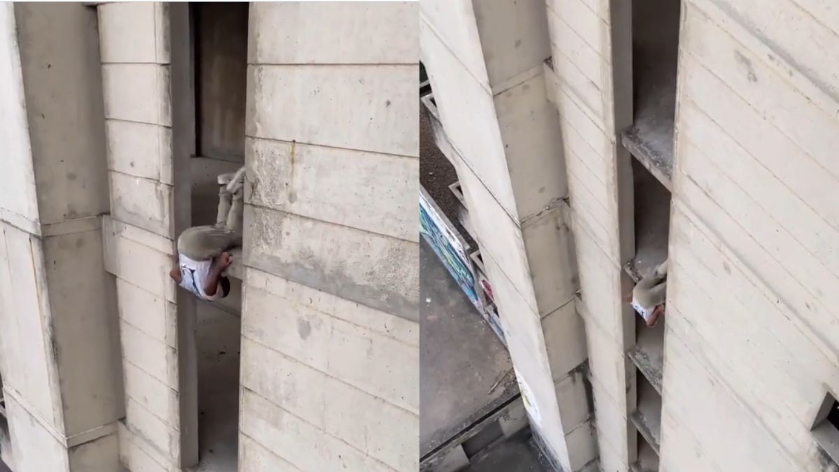 man swings down the building